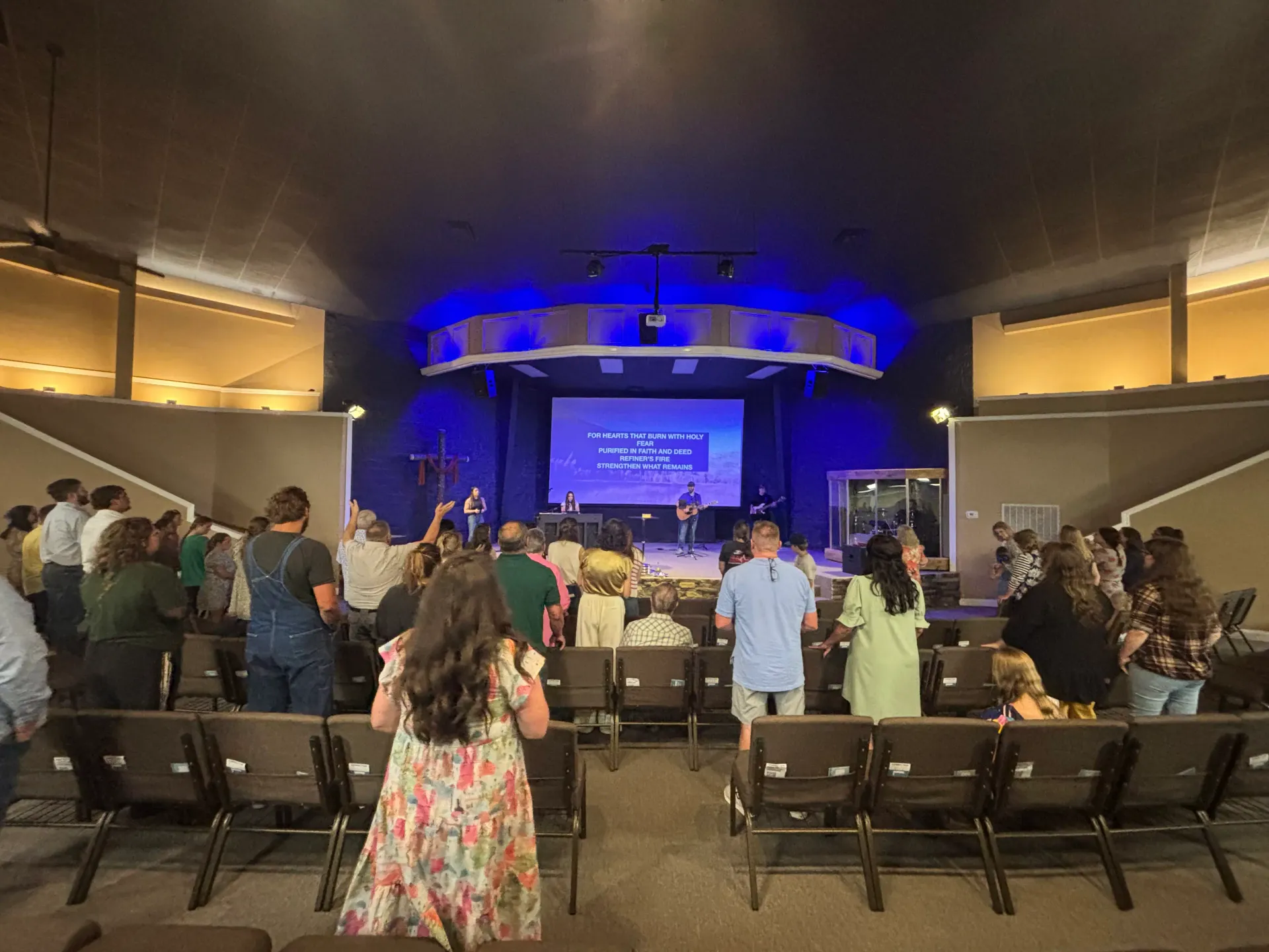 Cornerstone Assembly of God congregation worshiping together with the worship team on stage